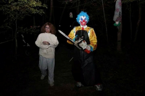 clown with chainsaw and victim
