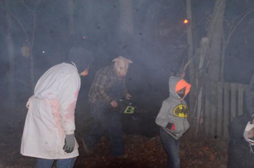 monsters-chasing-people-on-haunted-trail-with-chainsaw