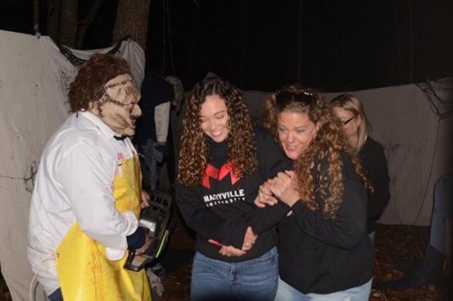 Haunted Woods Leatherface Scaring Guests with Chainsaw