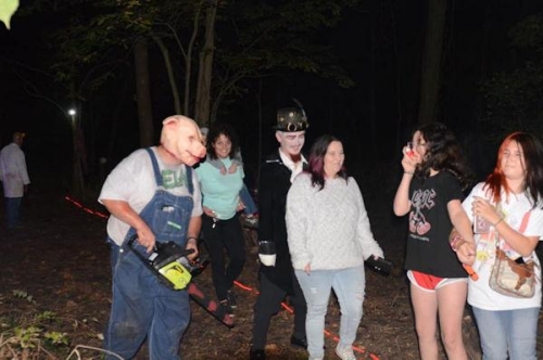 Haunted Woods Pig Man Scaring Guests with Chainsaw