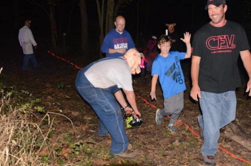 Haunted Woods Pig Man Scaring Boy with Chainsaw