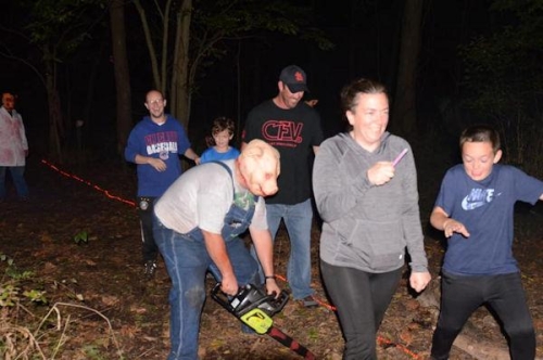 Haunted Woods Pig Man Scaring Guests with Chainsaw